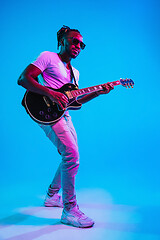 Image showing Young african-american jazz musician playing the guitar