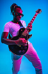 Image showing Young african-american jazz musician playing the guitar