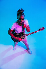 Image showing Young african-american jazz musician playing the guitar