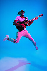 Image showing Young african-american jazz musician playing the guitar