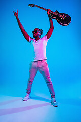 Image showing Young african-american jazz musician playing the guitar