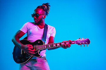 Image showing Young african-american jazz musician playing the guitar