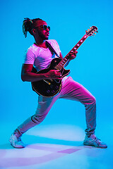 Image showing Young african-american jazz musician playing the guitar