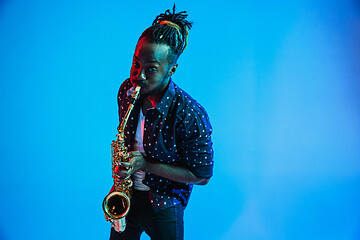 Image showing Young african-american jazz musician playing the saxophone