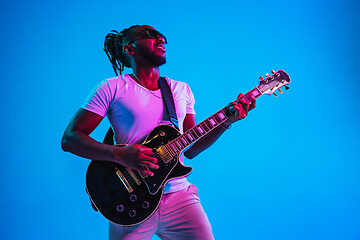 Image showing Young african-american jazz musician playing the guitar