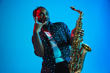 Image showing Young african-american jazz musician playing the saxophone