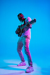 Image showing Young african-american jazz musician playing the guitar