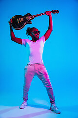 Image showing Young african-american jazz musician playing the guitar