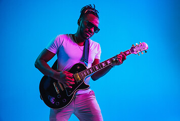 Image showing Young african-american jazz musician playing the guitar