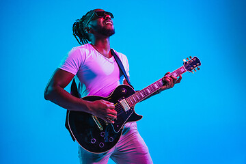 Image showing Young african-american jazz musician playing the guitar
