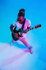 Image showing Young african-american jazz musician playing the guitar