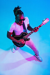 Image showing Young african-american jazz musician playing the guitar