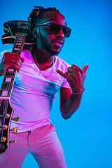 Image showing Young african-american jazz musician playing the guitar