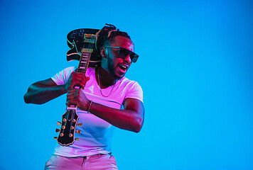 Image showing Young african-american jazz musician playing the guitar