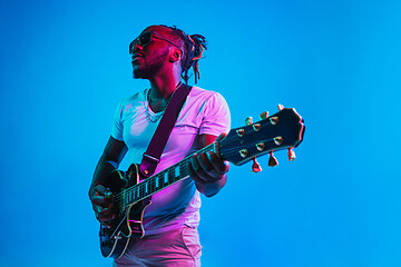 Image showing Young african-american jazz musician playing the guitar