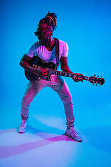 Image showing Young african-american jazz musician playing the guitar