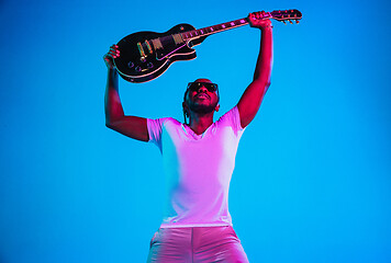 Image showing Young african-american jazz musician playing the guitar