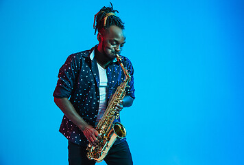 Image showing Young african-american jazz musician playing the saxophone