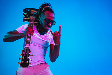 Image showing Young african-american jazz musician playing the guitar