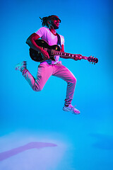 Image showing Young african-american jazz musician playing the guitar