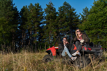 Image showing couple enjoying beautiful sunny day while driving a off road buggy