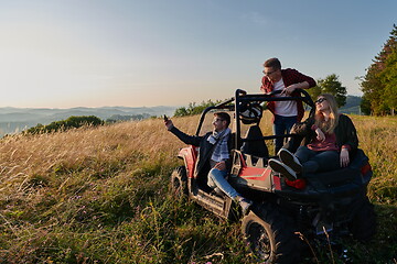 Image showing group young happy people enjoying beautiful sunny day while driving a off road buggy car