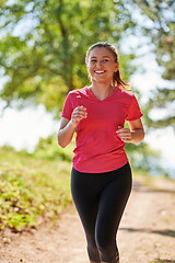 Image showing woman enjoying in a healthy lifestyle while jogging