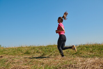 Image showing woman enjoying in a healthy lifestyle while jogging