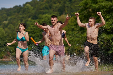 Image showing group of happy friends having fun on river