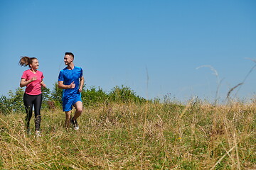 Image showing couple jogging in a healthy lifestyle on a fresh mountain air