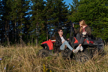 Image showing couple enjoying beautiful sunny day while driving a off road buggy