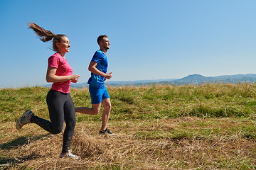 Image showing couple jogging in a healthy lifestyle on a fresh mountain air