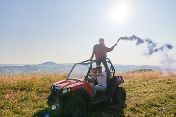 Image showing  colorful torches while driving a off road buggy car