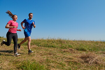 Image showing couple jogging in a healthy lifestyle on a fresh mountain air