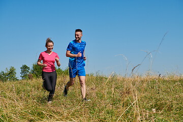 Image showing couple jogging in a healthy lifestyle on a fresh mountain air