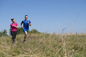 Image showing couple jogging in a healthy lifestyle on a fresh mountain air