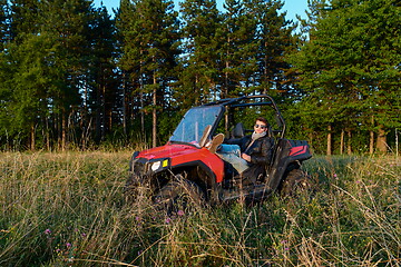 Image showing man enjoying beautiful sunny day while driving a off road buggy car