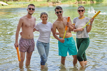 Image showing group of happy friends having fun on river