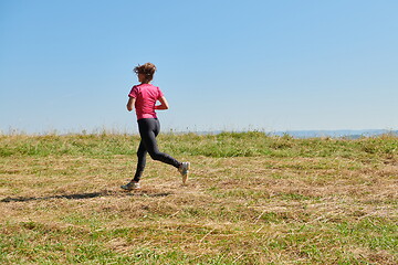 Image showing woman enjoying in a healthy lifestyle while jogging