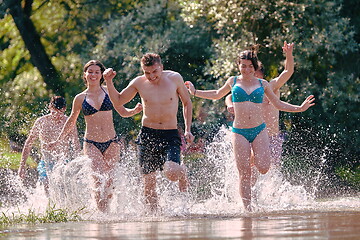 Image showing group of happy friends having fun on river