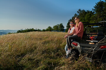 Image showing couple enjoying beautiful sunny day while driving a off road buggy