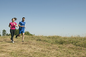 Image showing couple jogging in a healthy lifestyle on a fresh mountain air