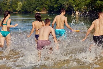 Image showing group of happy friends having fun on river