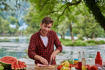 Image showing man cooking tasty food for french dinner party