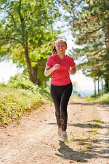 Image showing woman enjoying in a healthy lifestyle while jogging