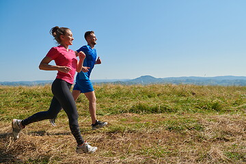 Image showing couple jogging in a healthy lifestyle on a fresh mountain air