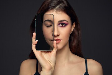 Image showing Lie and another life in social media. Girl with make up in photo frame and no make up in real life. Playing pretend.