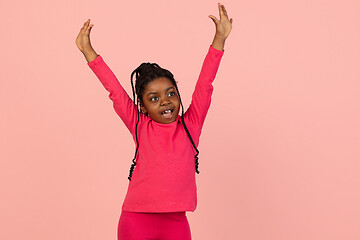 Image showing Handsome african little girl portrait isolated on pink studio background with copyspace