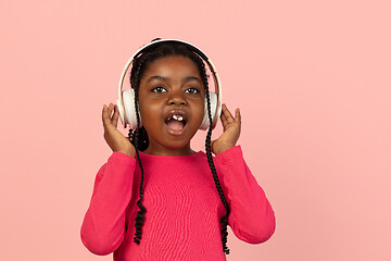 Image showing Handsome african little girl portrait isolated on pink studio background with copyspace