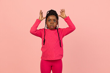 Image showing Handsome african little girl portrait isolated on pink studio background with copyspace